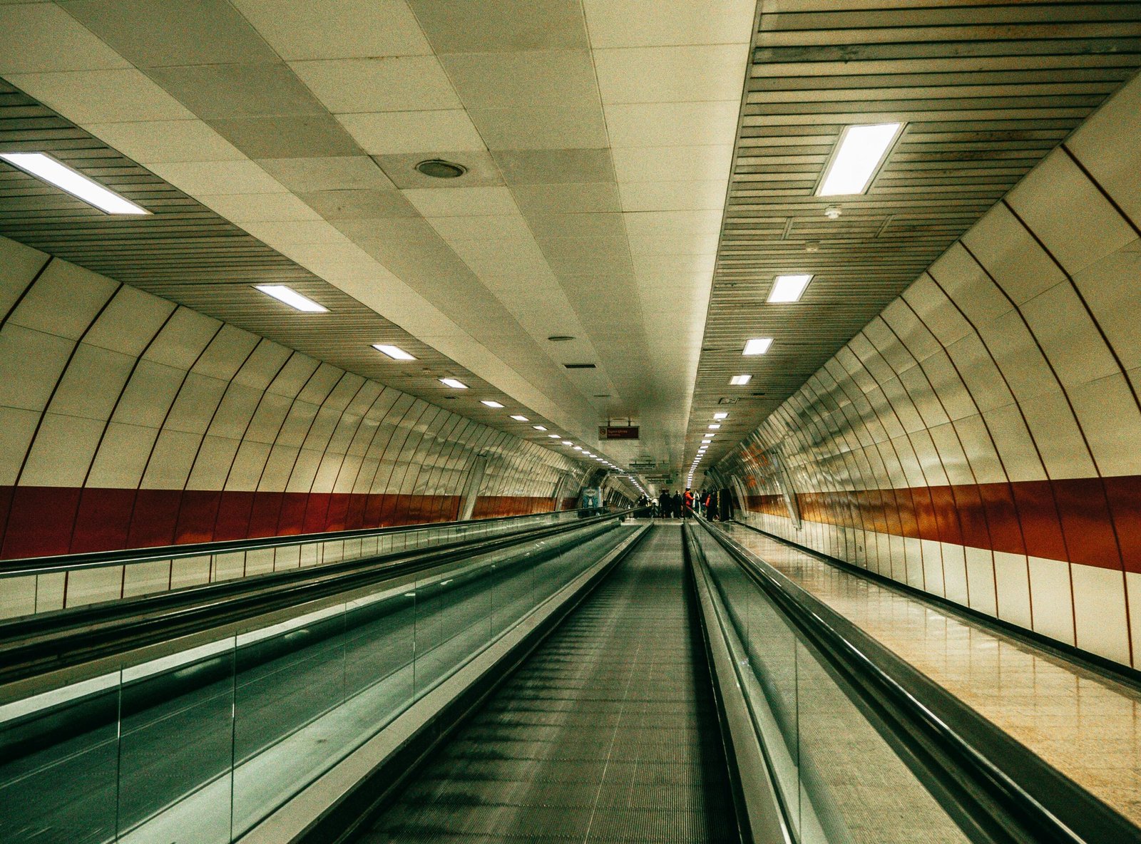 Long and narrow indoor moving walkway in a modern Istanbul metro station.